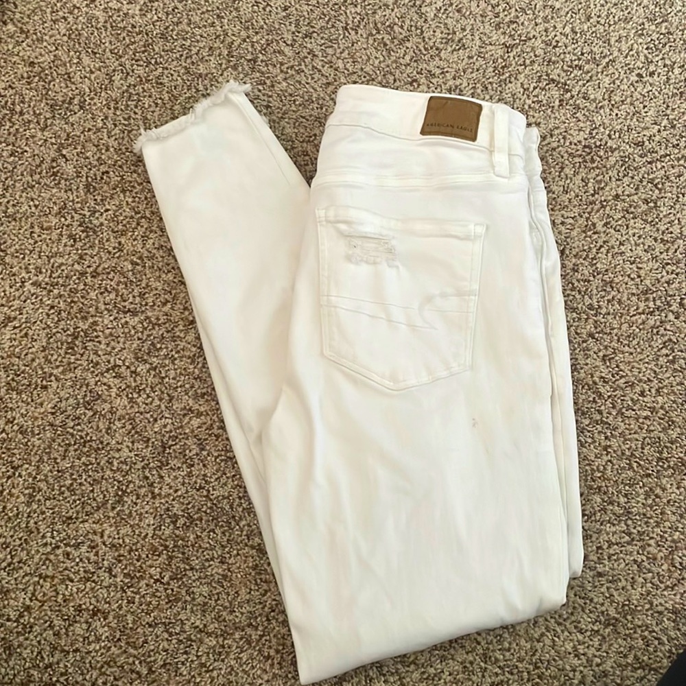 All white jeans. Slight rips in the front.
